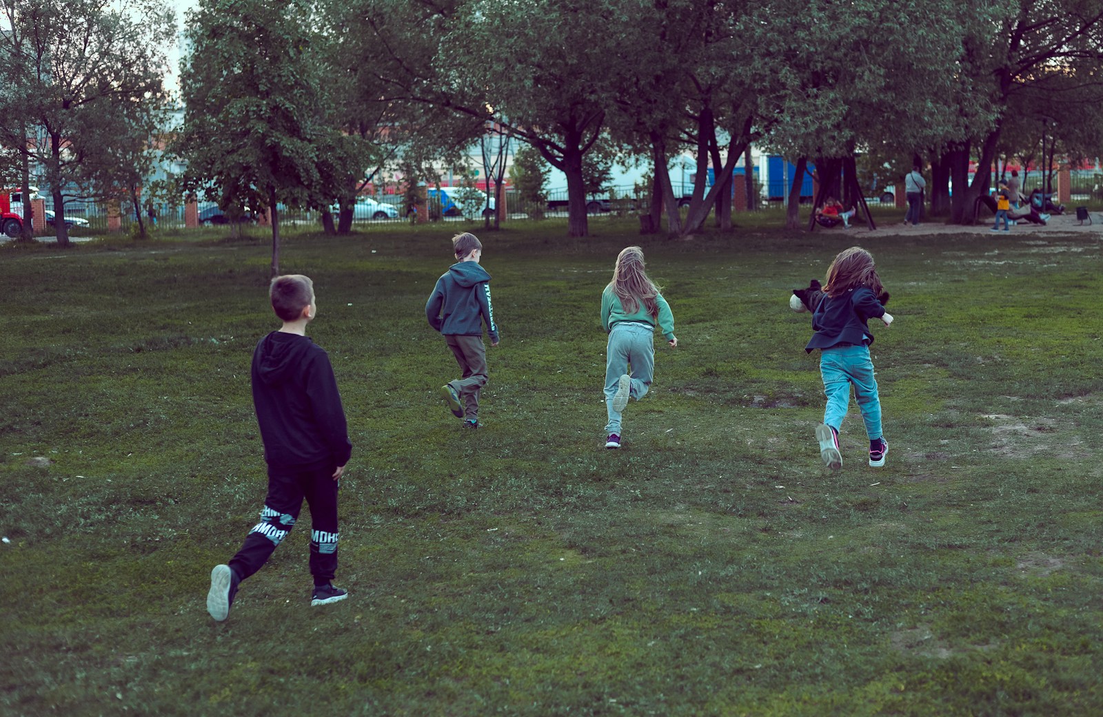 a group of young children playing a game of frisbee